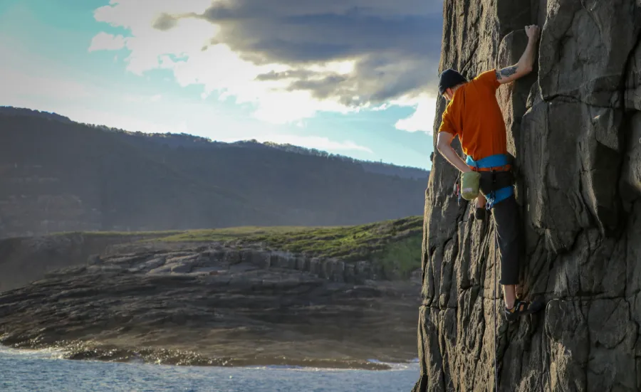 Image of man climbing mountain