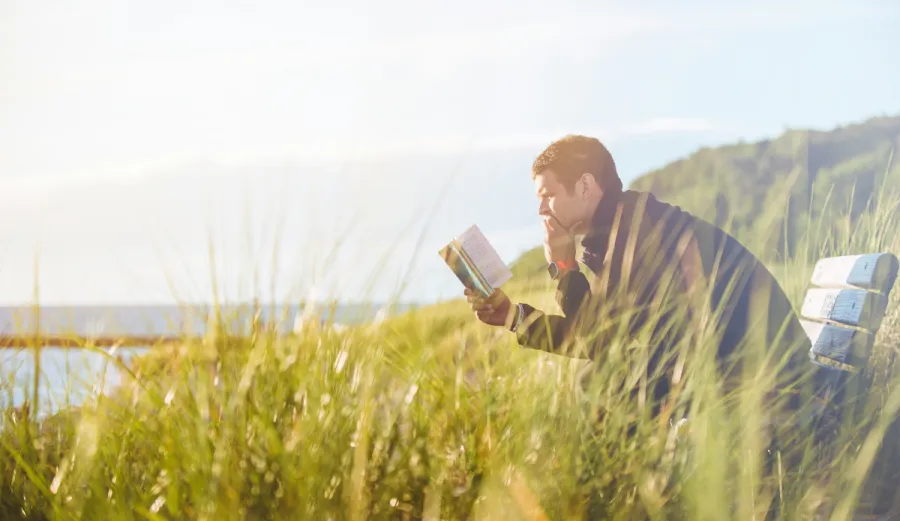Image of a man reading thoughtfully