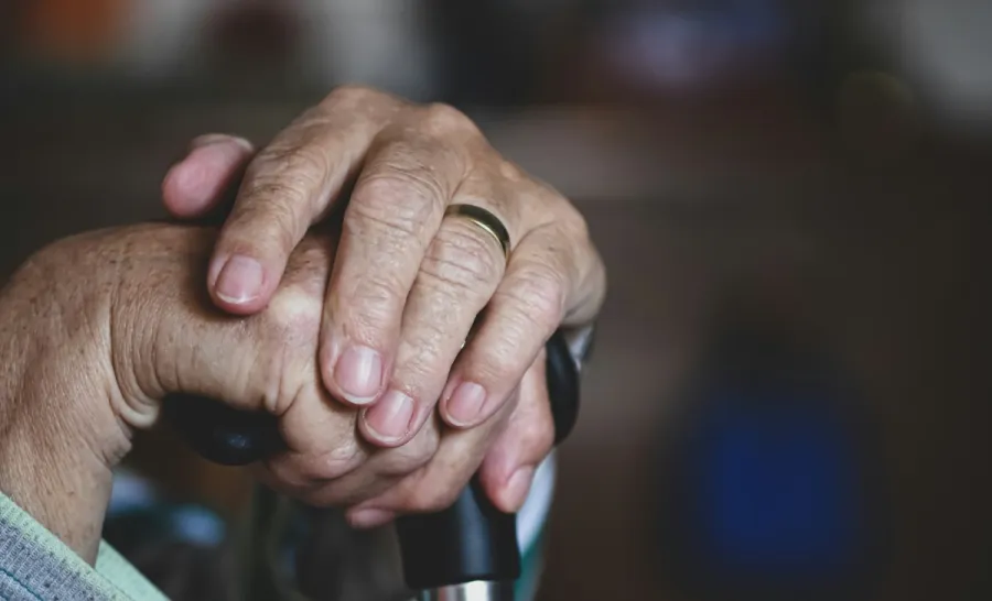 Image of elderly woman's hands on a cane