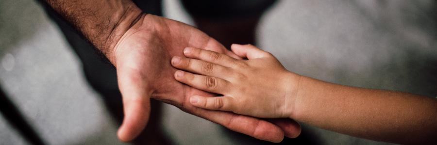 Image of father's hand and child's hand